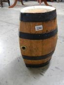 An old ship's whisky barrel with metal bands, 17" tall.