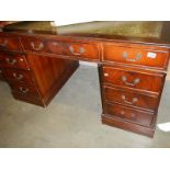 A large mahogany double pedestal desk with leather top.