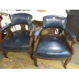 A pair of blue leather arm chairs.
