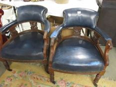 A pair of blue leather arm chairs.