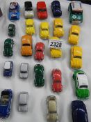 approximately 24 die cast cars including Volkswagen Beetles and Mini's etc.