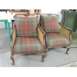 A pair of Bergere arm chairs.