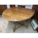 A mid 20th century oval oak gate leg table.