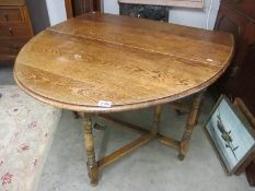 A mid 20th century oval oak gate leg table.