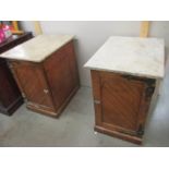 A pair of old bedside cabinets with marble tops and heavy brass hinges, possibly Scottish.