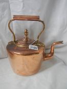 A Victorian copper kettle with bronze handle.