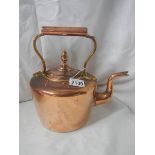 A Victorian copper kettle with bronze handle.