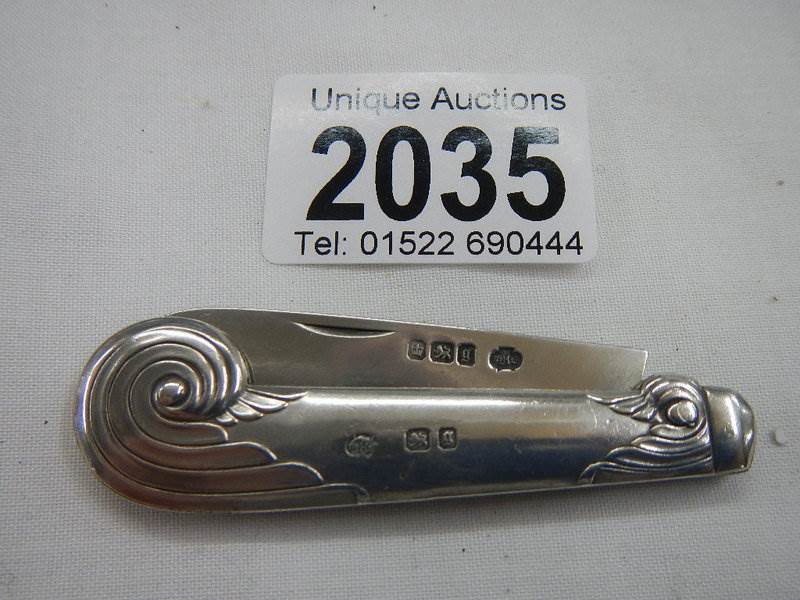 A decorative hall marked silver folding fruit knife.