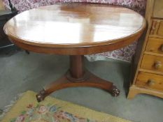 A Victorian mahogany circular tip top table on platform base, 40" diameter.