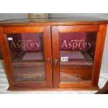 A mahogany jewellery cabinet signed for Asprey's.