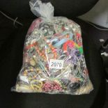 A 7 kilo bag of mixed costume jewellery.