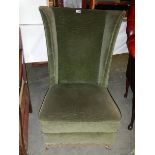 An Edwardian wing arm chair.