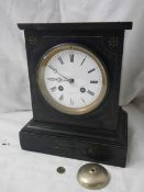 A black marble chiming mantel clock.