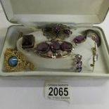 A collection of late 19th century brooches with amethyst coloured stones together with other