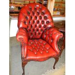 A deep buttoned Queen Anne leg arm chair in deep tan.