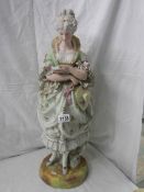 A tall bisque figure of a lady, 25" tall, a/f see images.