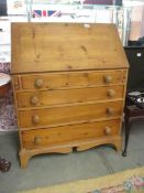 A good quality mid 20th century pine bureau with fitted interior, 33" wide.