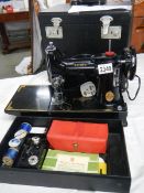 A Singer featherweight portable sewing machine, model No.