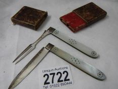 A 1920's silver folding knife and fork set with mother of pearl handles in original box (no makers