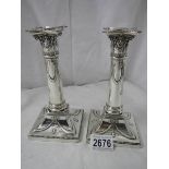 A pair of hall marked silver candlesticks, 7" tall, in good condition.