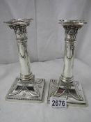 A pair of hall marked silver candlesticks, 7" tall, in good condition.