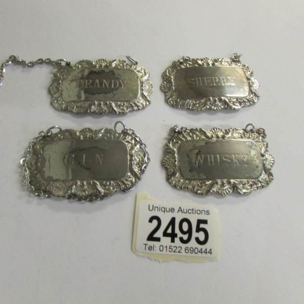 4 silver plate spirit labels.