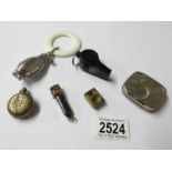 A penguin rattle, 2 cigar cutters, a sovereign case, a coin case and a whistle.