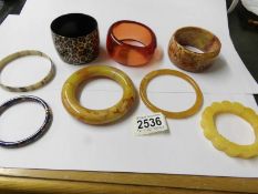 8 plastic bangles on stand.