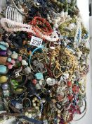 A large quantity of unsorted costume jewellery.