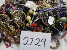 A large quantity of unsorted costume jewellery.