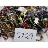 A large quantity of unsorted costume jewellery.