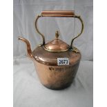 A Victorian circular copper kettle with bronze acorn lid knob.