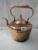 A Victorian circular copper kettle with bronze acorn lid knob.