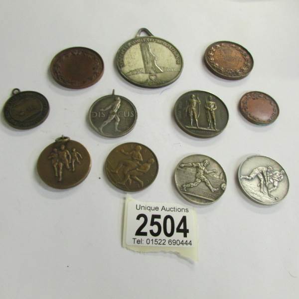 11 vintage sports medals.