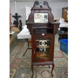 An Edwardian mahogany cabinet signed for Chanel No. 5.