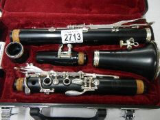 A good quality silver plated "Jupiter" cased clarinet with spare reed.