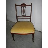 A mahogany inlaid bedroom chair in good condition.