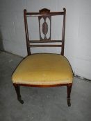 A mahogany inlaid bedroom chair in good condition.