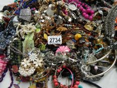 A large quantity of unsorted costume jewellery.