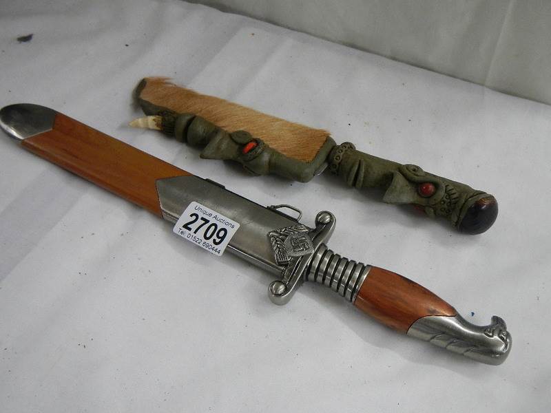 2 20th century knives including one with handle shaped as head.