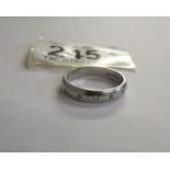 An all platinum five stone diamond band wedding ring with round cut diamonds,