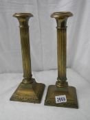 A pair of old brass reeded candlesticks, 12" tall, in good condition.