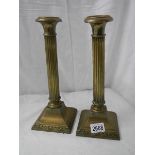 A pair of old brass reeded candlesticks, 12" tall, in good condition.
