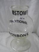 A glass advertising sweet jar with glass lid, 13" tall.