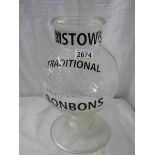 A glass advertising sweet jar with glass lid, 13" tall.