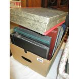 An interesting box of stamp albums, postcards,