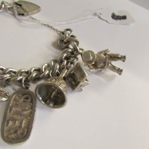 A very good quality 1970's charm bracelet with 11 charms in total including 4 opening, - Image 4 of 4