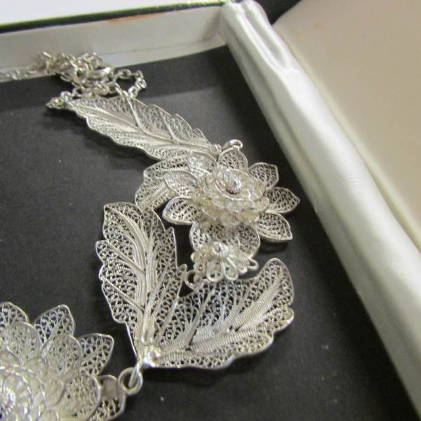 A vintage silver filigree necklace fashioned with flowers and leaves, attached pendant drop, - Image 2 of 3