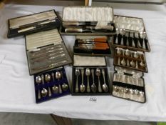 A mixed lot of cased cutlery including fish servers, carving set, spoons, knives etc.