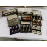 A mixed lot of cased cutlery including fish servers, carving set, spoons, knives etc.
